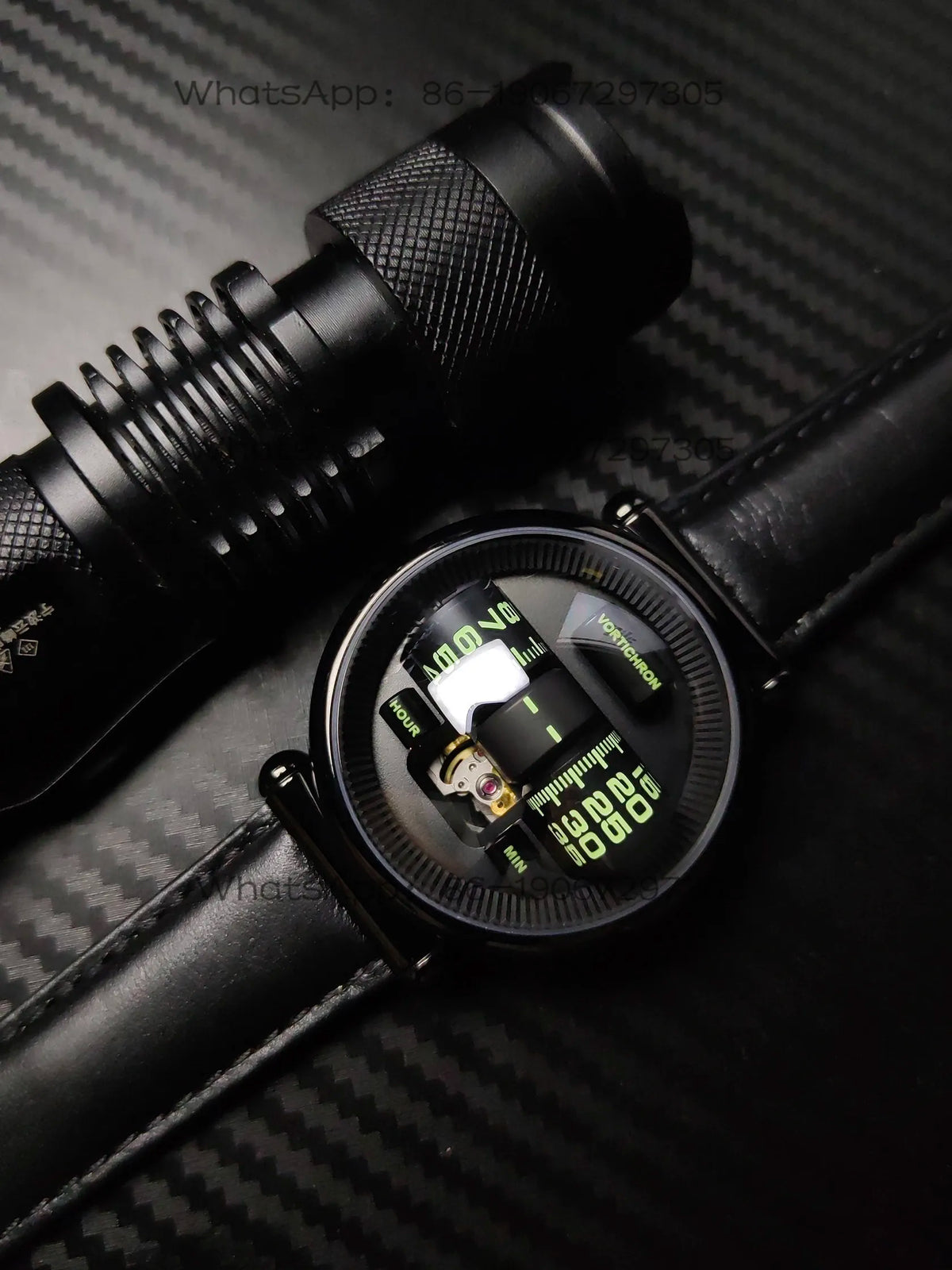Black wristwatch with digital display on a textured black background