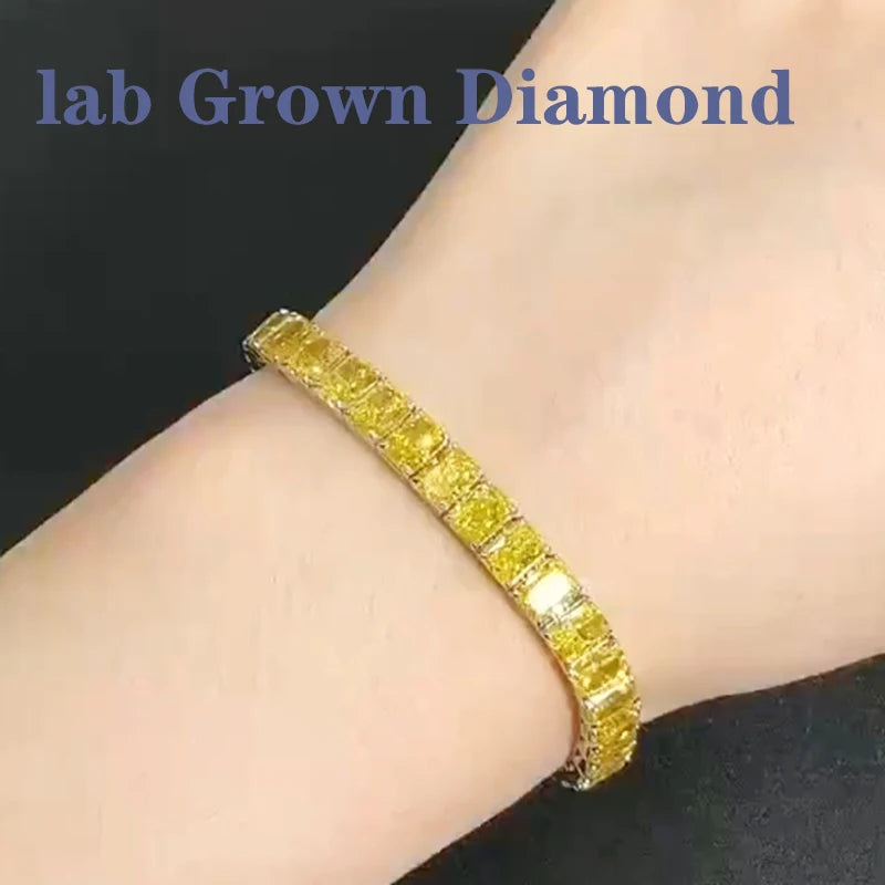 Gold bracelet with yellow gemstones on a wrist, labeled 'lab Grown Diamond'.