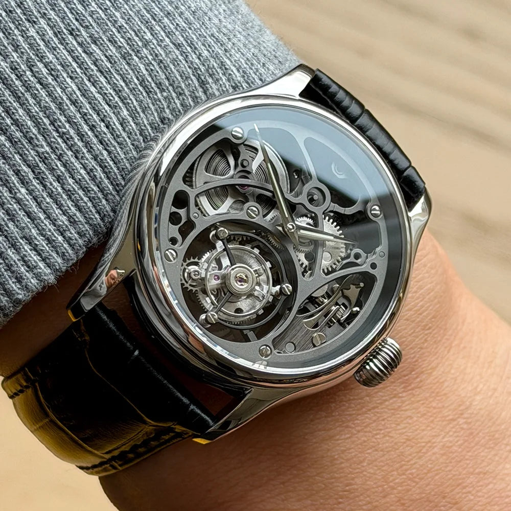 Close-up of a wrist wearing a detailed mechanical watch with a black strap.