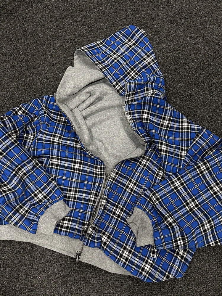 Blue plaid jacket with gray hood and cuffs on a dark background