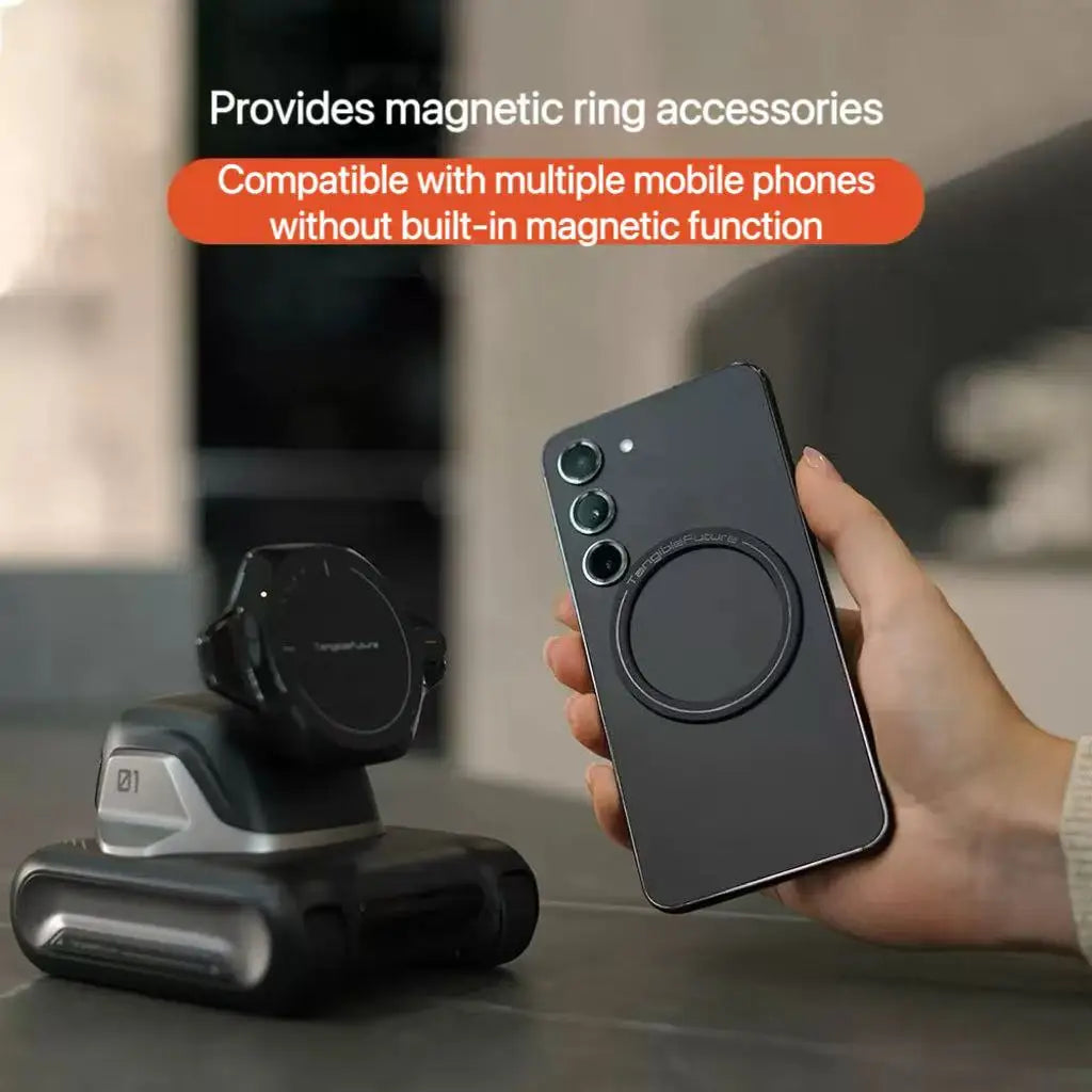 Smartphone with magnetic ring accessory held by a hand, with a stand in the background.
