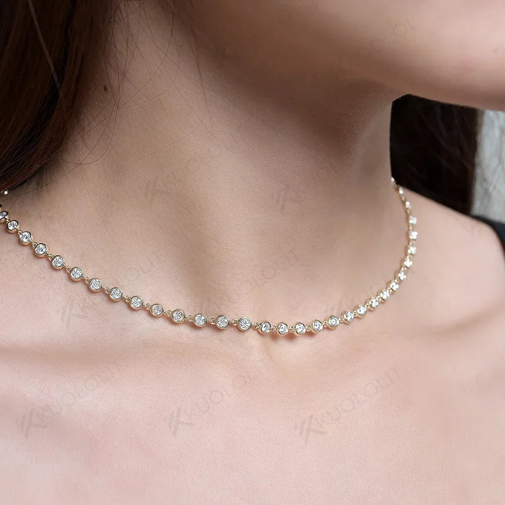Close-up of a person wearing a delicate gold necklace with small diamonds.