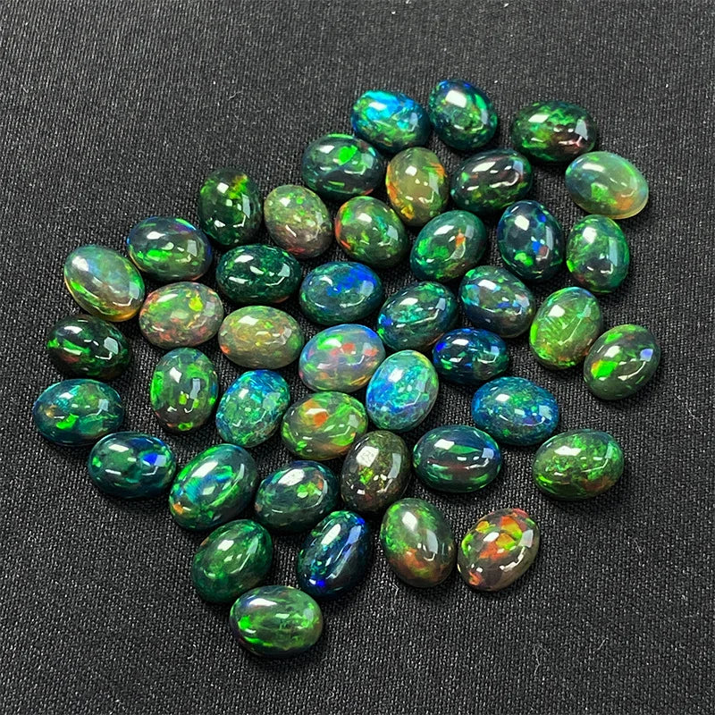Collection of green opal stones on a dark background