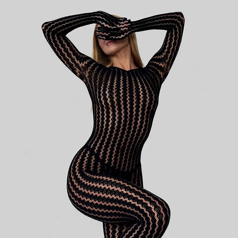Person wearing a black and gold patterned outfit on a gray background