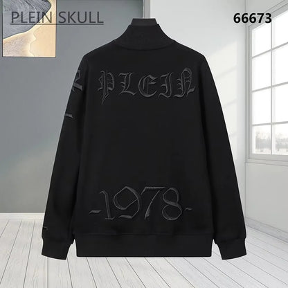 A black long-sleeve mock-neck sweatshirt with tonal dark gray gothic lettering reading 'PLEIN' across the chest and '1978-' near the hem, displayed on a mannequin in a bright room setting.