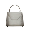 A structured handbag with a crocodile-embossed texture in a light taupe-gray color, featuring a top handle and silver-tone hardware, shown against a plain white background.