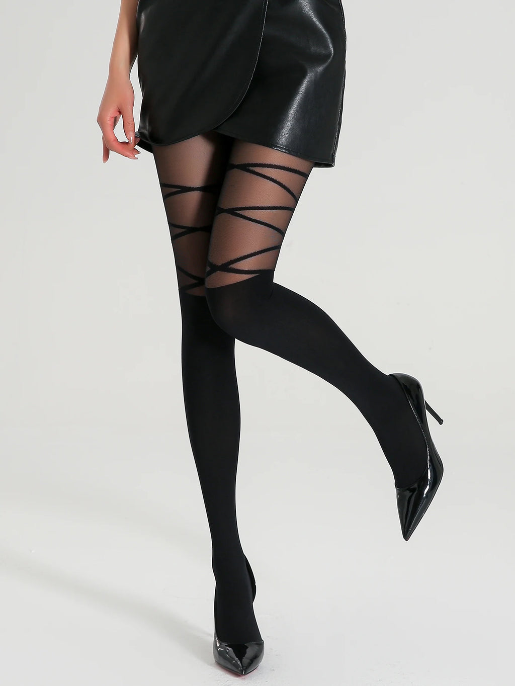 Person wearing black tights with lace-up design on a white background