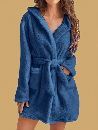 Blue robe worn by a person on a beige background