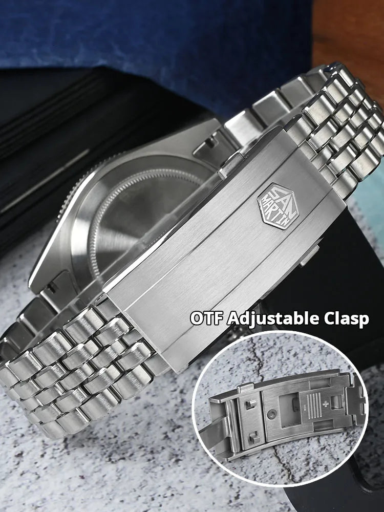 Metallic watch with OTF adjustable clasp on a textured surface