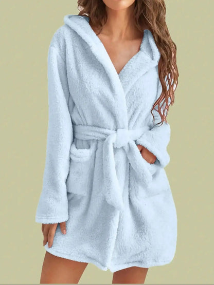 Light blue robe worn by a person on a beige background