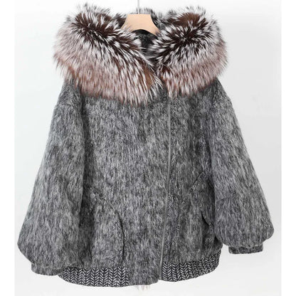A gray faux fur jacket with a large brown and white fox fur collar, displayed on a wooden hanger against a white background.