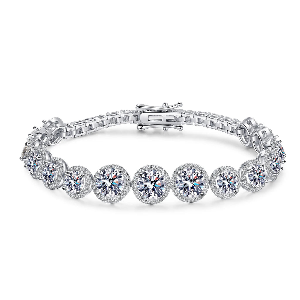 A silver tennis bracelet featuring round-cut clear gemstones in halo settings, displayed on a clean white background.