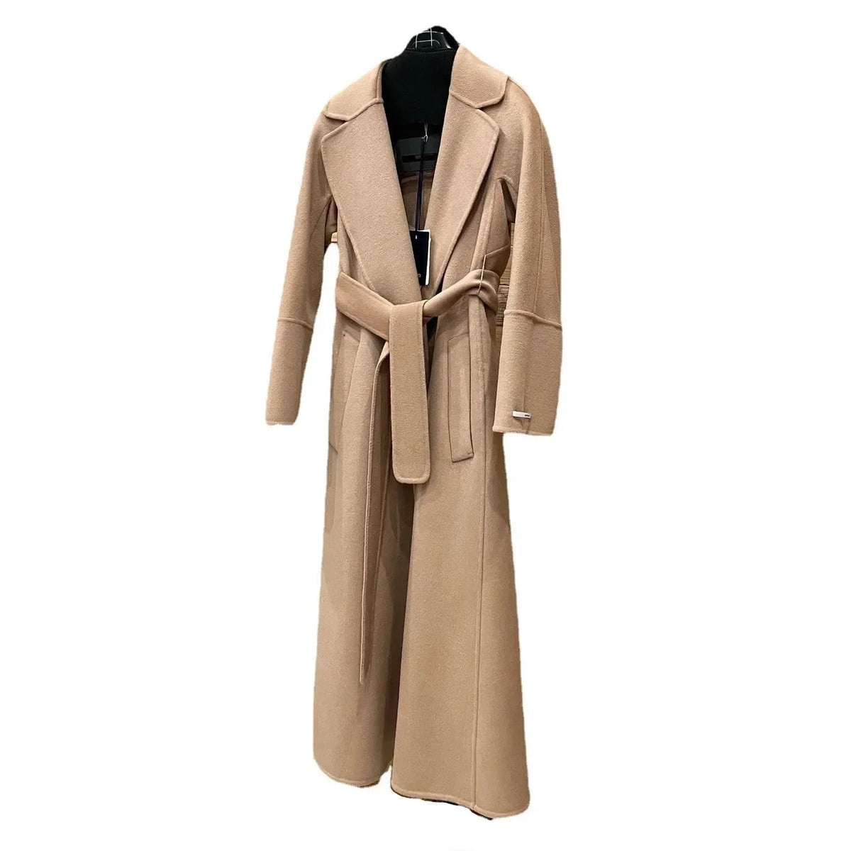 A long camel-colored wool coat with a matching waist tie belt, displayed on a black hanger against a plain white background.