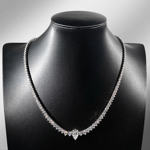 Diamond necklace on a black mannequin bust against a gray background