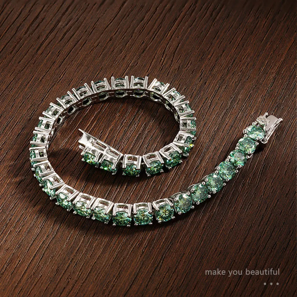 Silver bracelet with green gemstones on a wooden surface