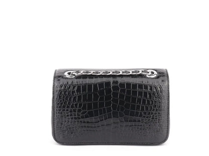 A black crocodile-embossed leather clutch bag with a silver-tone chain detail across the top, shown against a plain white background.
