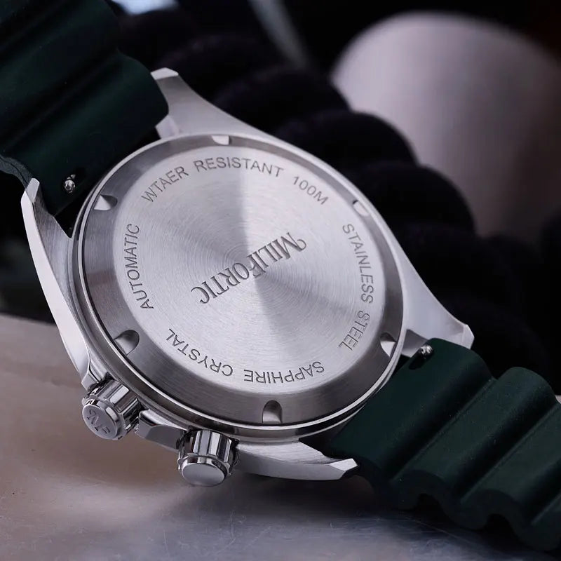 Close-up of a watch with visible brand name on the back, on a dark background.