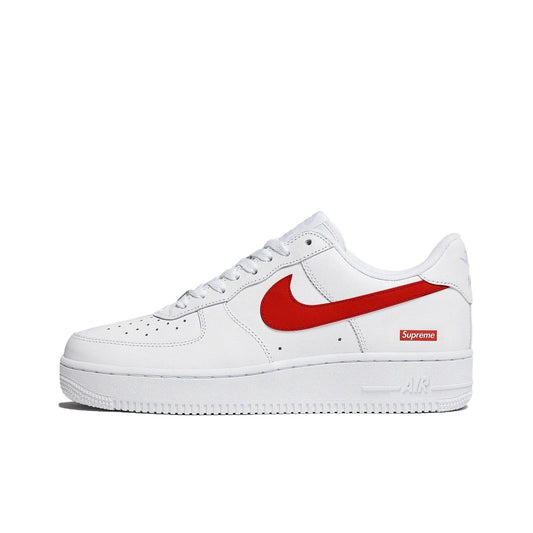 A white Nike Air Force 1 sneaker with a red Swoosh and a red Supreme box logo on the side, shown against a plain white background.