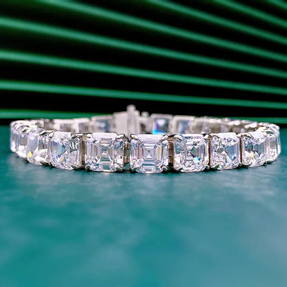 Diamond bracelet on a teal surface with a green background