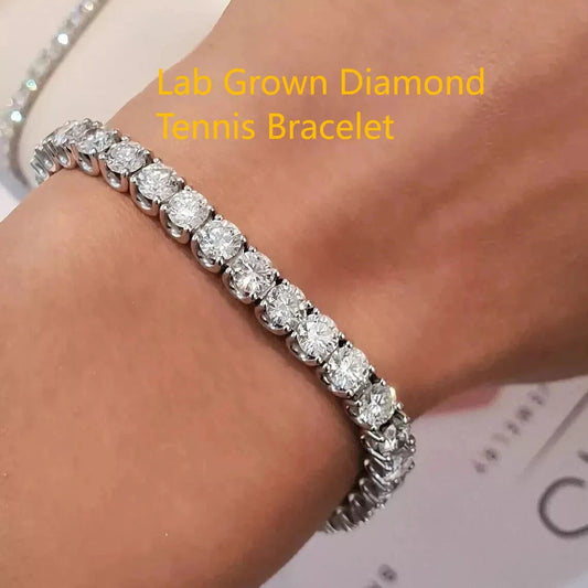 A close-up of a diamond tennis bracelet worn on a wrist, featuring round brilliant-cut lab-grown diamonds set in a silver-toned metal. Yellow text overlay reads 'Lab Grown Diamond Tennis Bracelet'.