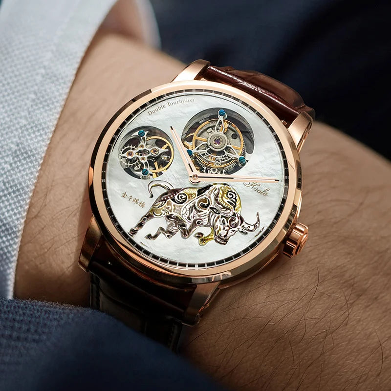 A close-up lifestyle shot of a men's skeleton watch on a wrist. The watch features a rose gold case, a white mother-of-pearl dial with a detailed gold and silver bull skeleton design, and a brown leather strap.