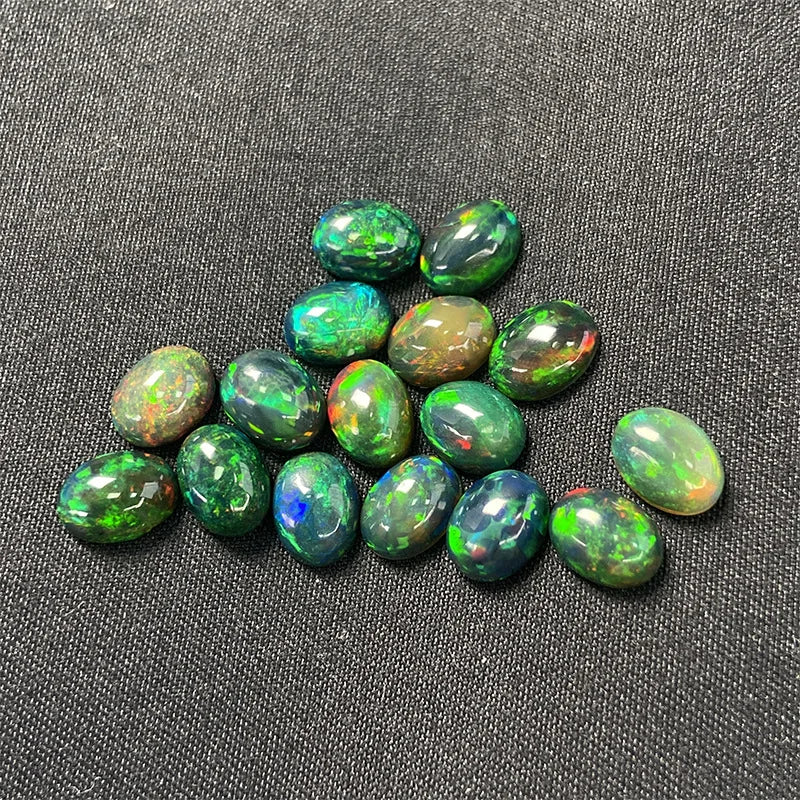 Collection of green opal stones on a dark fabric background