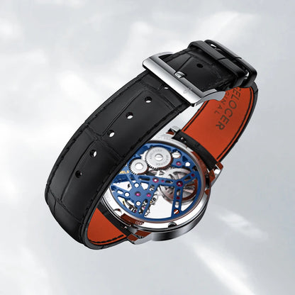 Luxury watch with black leather strap and visible mechanical components on a light gray background