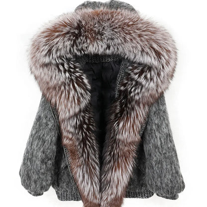 A women's winter coat with a large, luxurious shaggy faux-fur trimmed hood and collar, featuring a textured gray knit body and a black lined interior, shown against a plain white background.