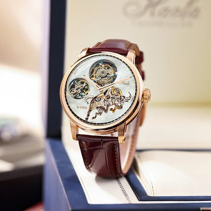 A luxury skeleton watch with a rose gold case, brown leather strap, and intricate mechanical movement visible through the white dial, displayed inside an open presentation box.