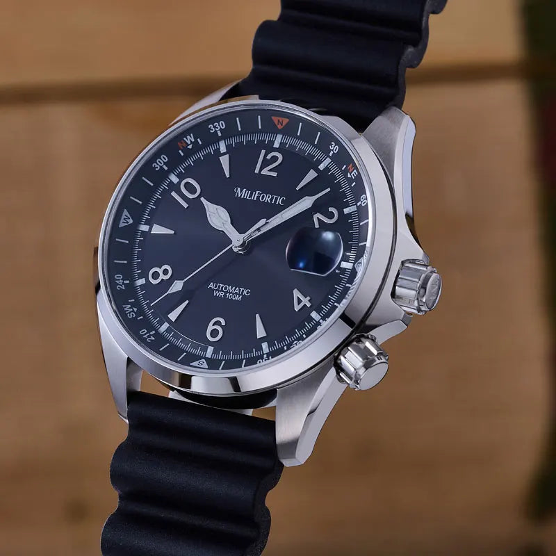 Watch with black strap and blue dial on a wooden surface