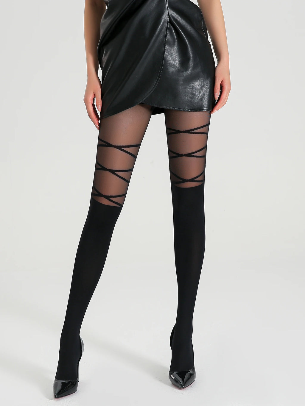 Black thigh-high stockings with criss-cross straps worn by a model on a white background