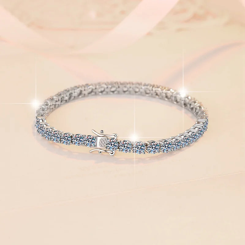 Silver bracelet with clear stones on a light pink background