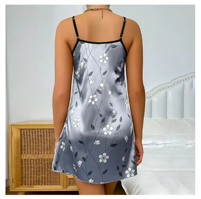 Woman wearing a gray floral slip dress in a bedroom setting
