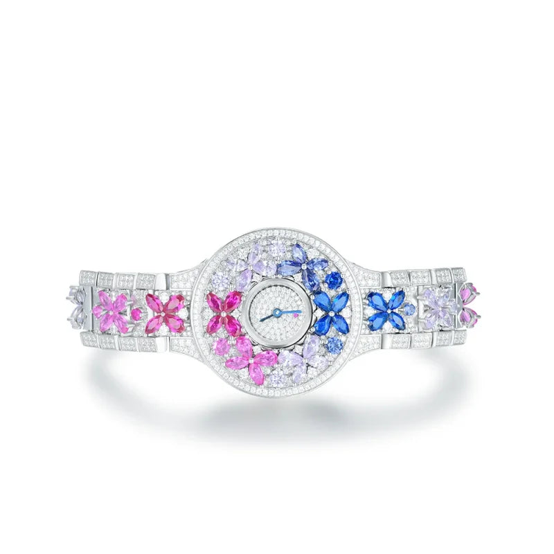 Elegant watch with colorful gemstone accents on a white background