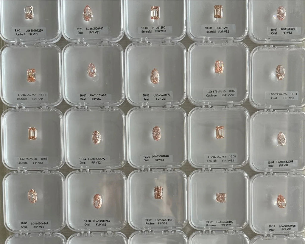 Multiple small diamonds in clear display cases on a grid pattern