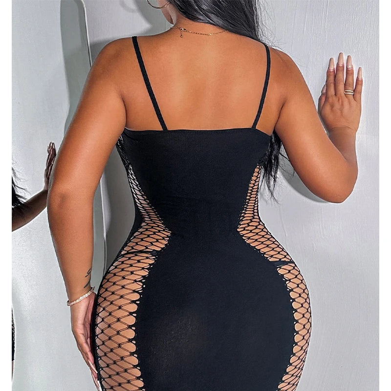 Black dress with fishnet detailing on a plain background