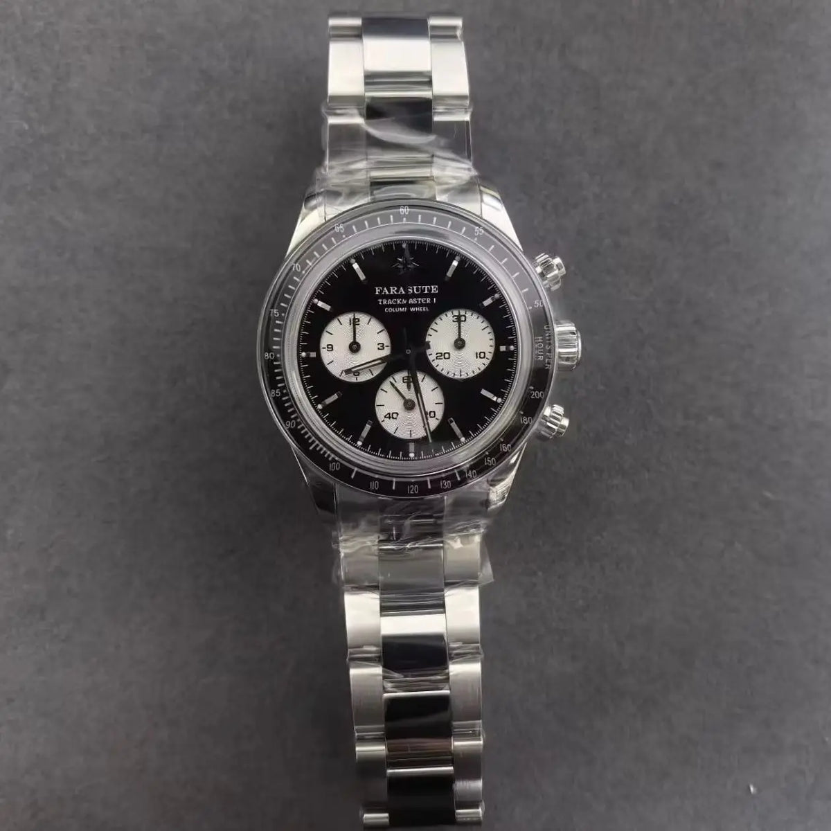 A Parachease chronograph watch with a black dial, silver-tone stainless steel case and bracelet, and white subdials, shown on a dark gray textured background.
