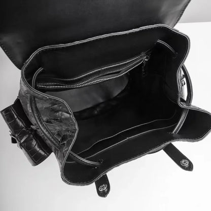 Black textured leather handbag shown open from above, revealing a spacious interior with a zippered pocket and dark lining on a white background.
