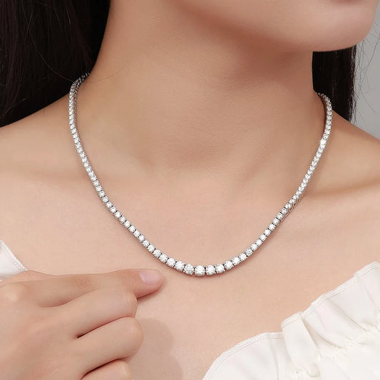 Silver necklace being worn by a person with a neutral background