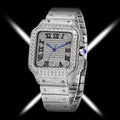 A luxury watch with a silver-toned rectangular case and integrated bracelet, heavily embellished with sparkling pavé stones. The watch face features black Roman numeral hour markers, silver hands, and a small blue cabochon accent on the crown, set against a black background with dramatic white light streaks.