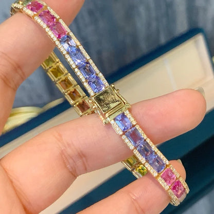 Multicolored gemstone bracelet on a hand with a blurred background