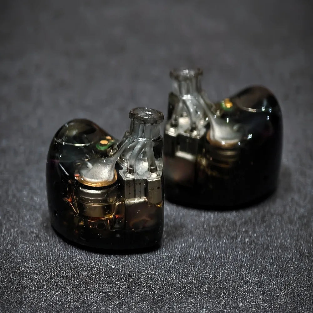 Close-up of transparent earbud components on a dark background