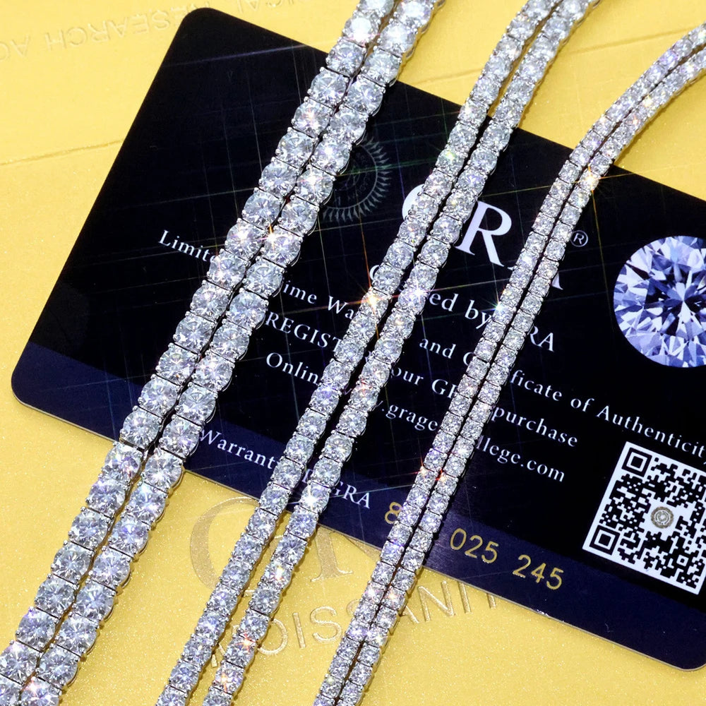 Diamond necklaces on a yellow surface with a GIA card in the background