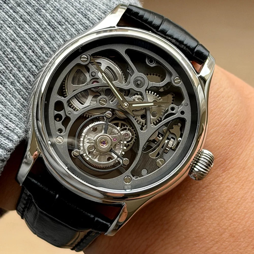 Mechanical watch with black leather strap on wrist
