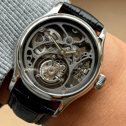 Mechanical watch with black leather strap on wrist