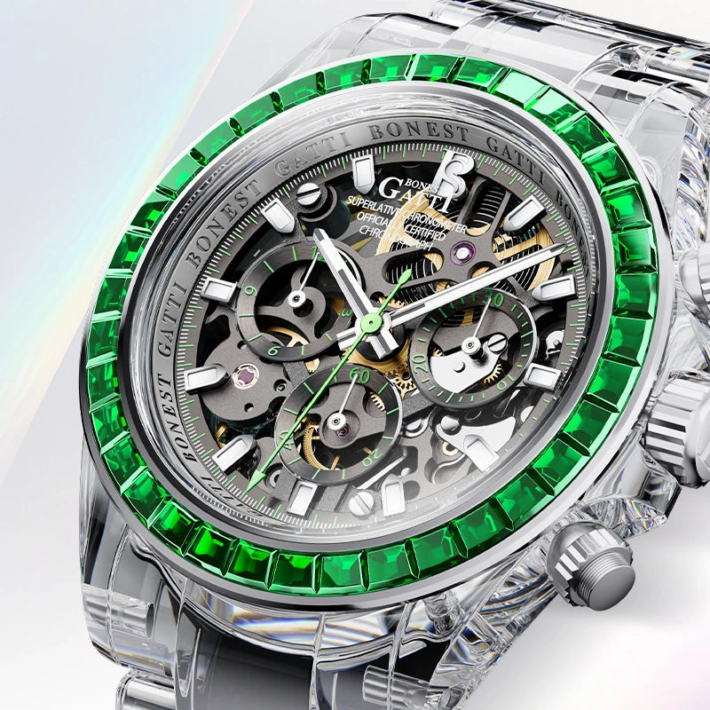 A luxury skeleton watch with a silver-tone stainless steel case, featuring a bezel lined with vivid green gemstones and a complex multi-dial mechanical movement visible through the open dial.