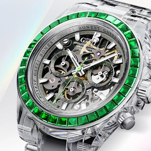 A luxury skeleton watch with a silver-tone stainless steel case, featuring a bezel lined with vivid green gemstones and a complex multi-dial mechanical movement visible through the open dial.