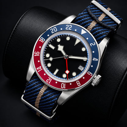 Watch with blue and red bezel and multicolored strap on a brown leather surface, featuring ADDIESDIVE branding.