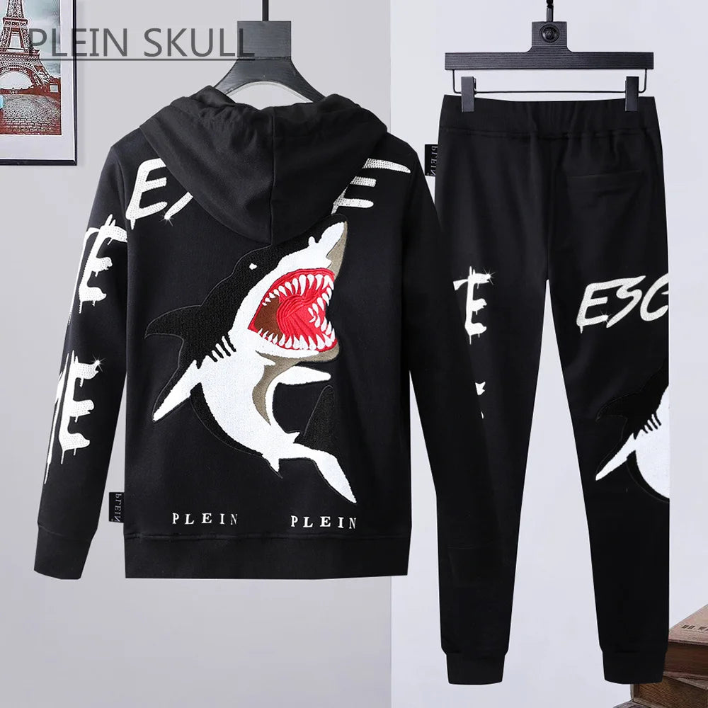 Black hoodie and pants set with shark design and 'PLEIN' branding on a white background.
