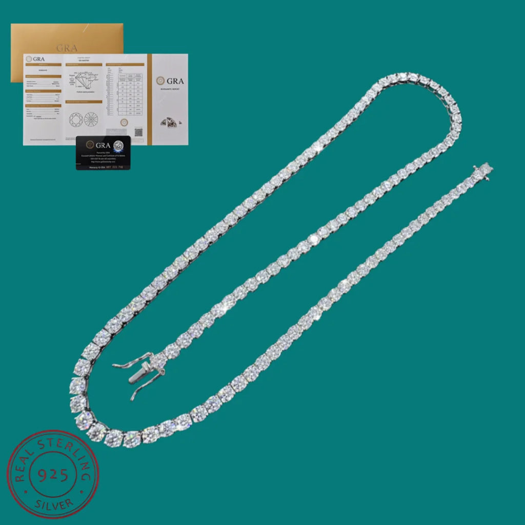 A diamond tennis necklace in a silver setting, displayed on a solid teal background with its GIA certificate and box in the upper left corner.